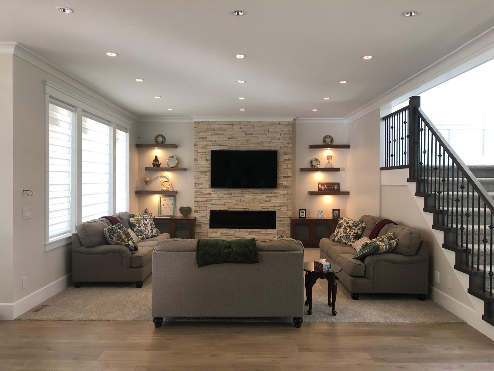 Marble feature wall with electric fireplace and recessed lighting
